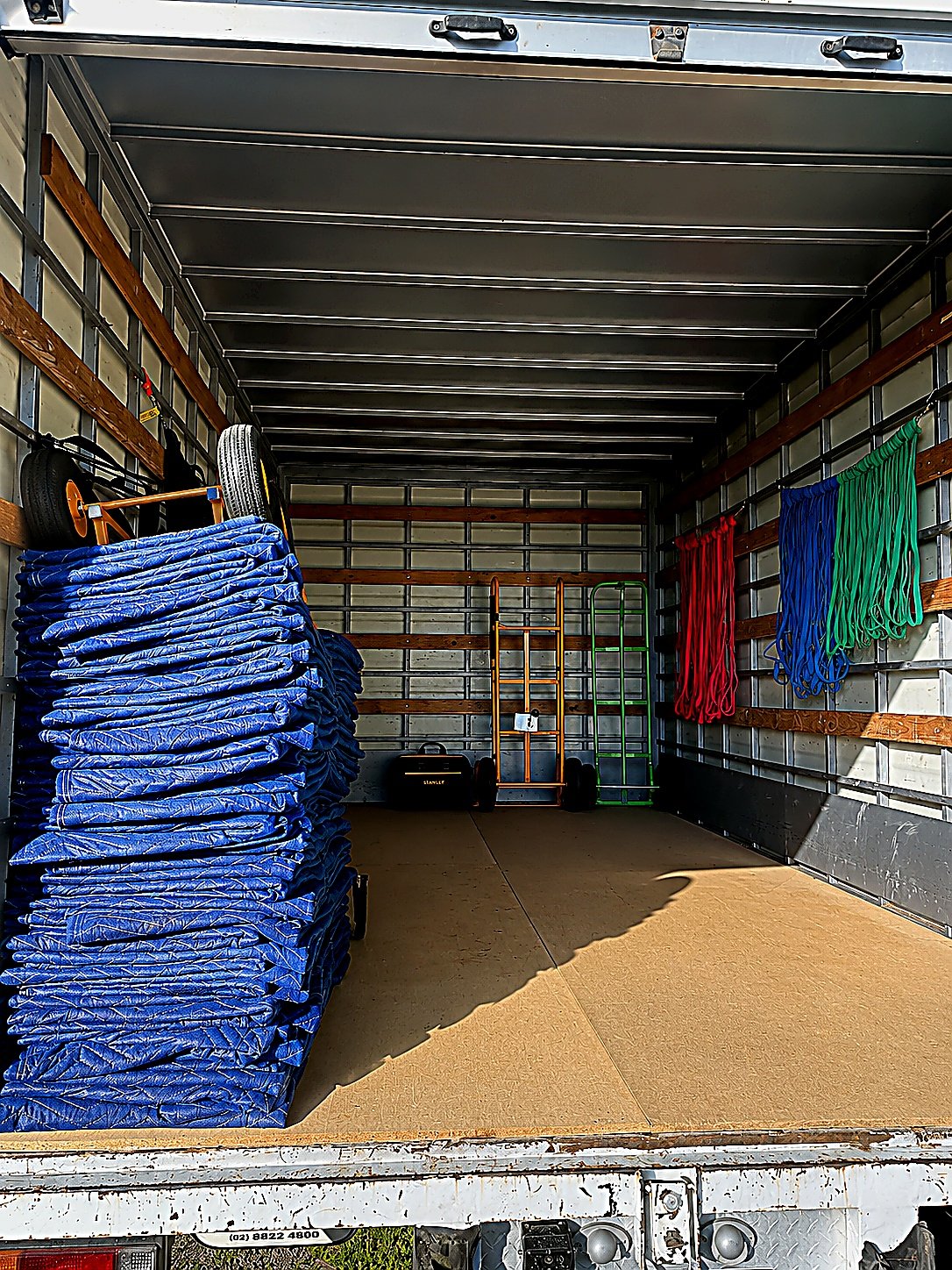 Empty removals truck ready to load with blankets and trolleys
